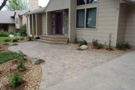 Front entry stoop and steps with 3 piece cobblestone paver entrance walk.